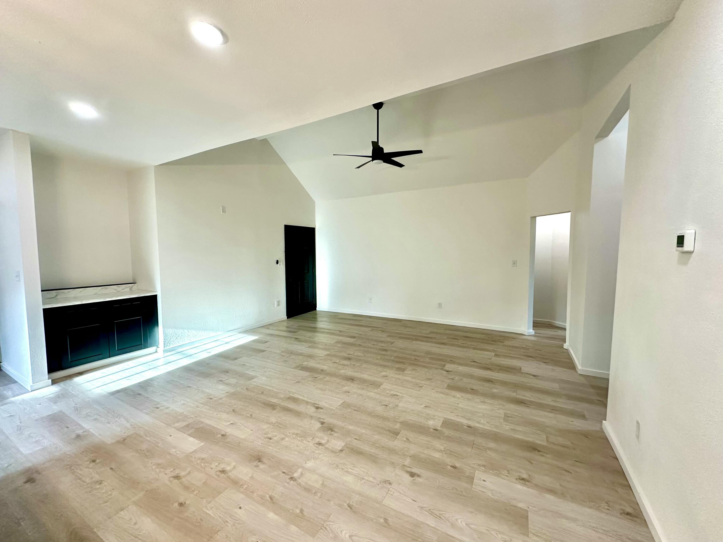 2617 47th Street Lubbock, TX 79413 - Photo 2 of 12 a view of an empty room with a fireplace and a window