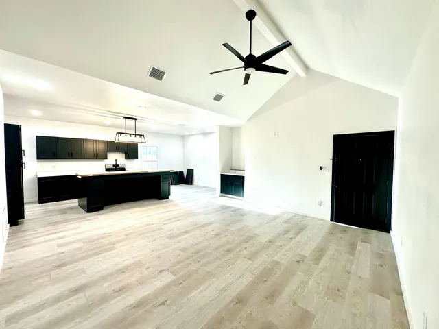 a large kitchen with stainless steel appliances kitchen island sink and refrigerator