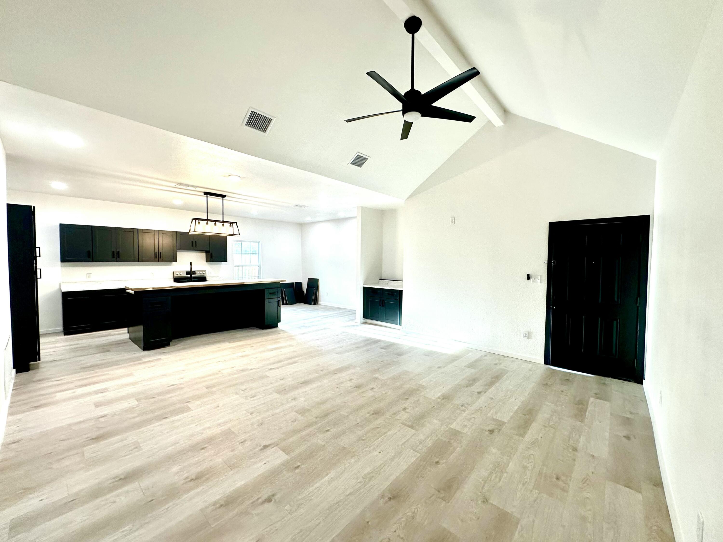 2617 47th Street Lubbock, TX 79413 - Photo 3 of 12 a large kitchen with stainless steel appliances kitchen island sink and refrigerator