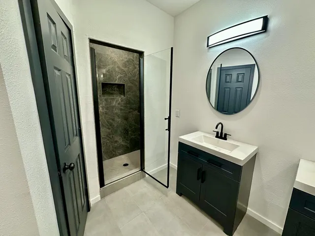 a bathroom with a sink and mirror