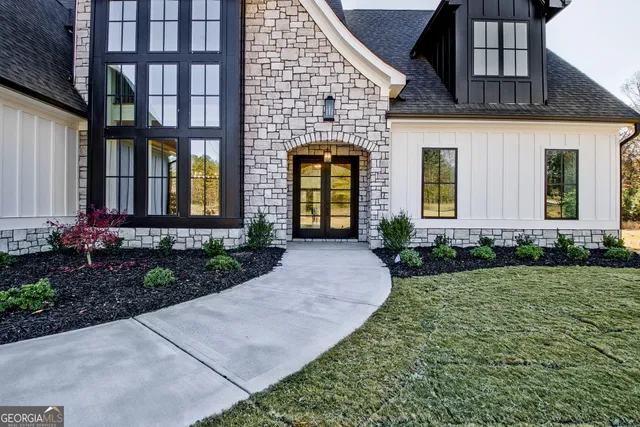 a large kitchen with stainless steel appliances a sink and a stove