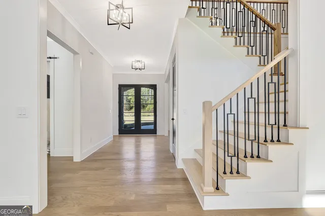 a large white kitchen with a refrigerator a stove and a sink