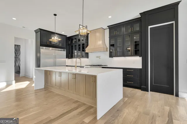 a view of a kitchen with wooden floor and windows