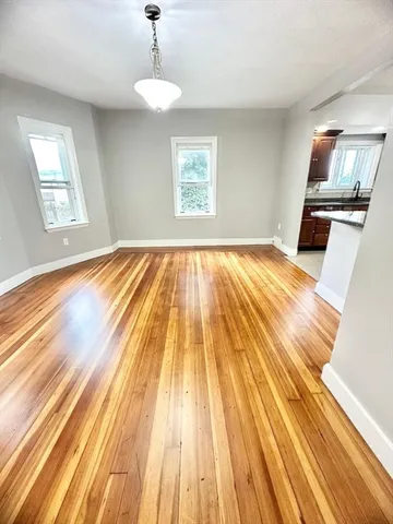 a view of wooden floor in a room with a window