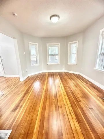 a view of wooden floor in a room with a window