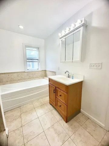 a bathroom with a bathtub and shower