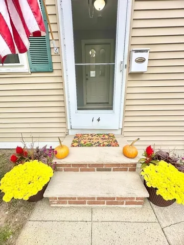 a large kitchen with cabinets and a wooden floor