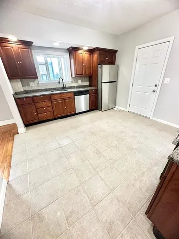a kitchen with furniture and flat screen tv