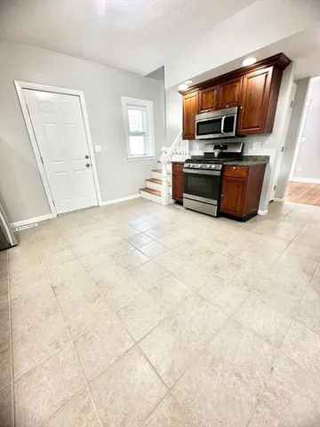 a kitchen with granite countertop sink and window