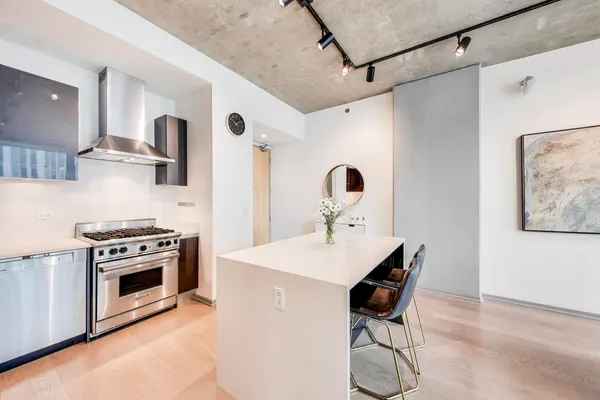 a kitchen with stainless steel appliances a stove a refrigerator and a cabinets