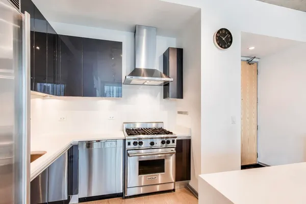 a kitchen with a stove a sink dishwasher and a refrigerator