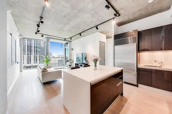 a kitchen with stainless steel appliances a refrigerator and a stove top oven