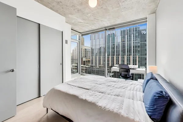 a bedroom with a bed and a table in it