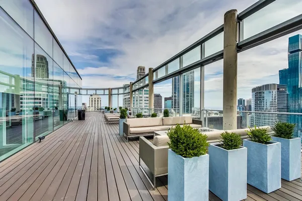 a living room with furniture and floor to ceiling windows