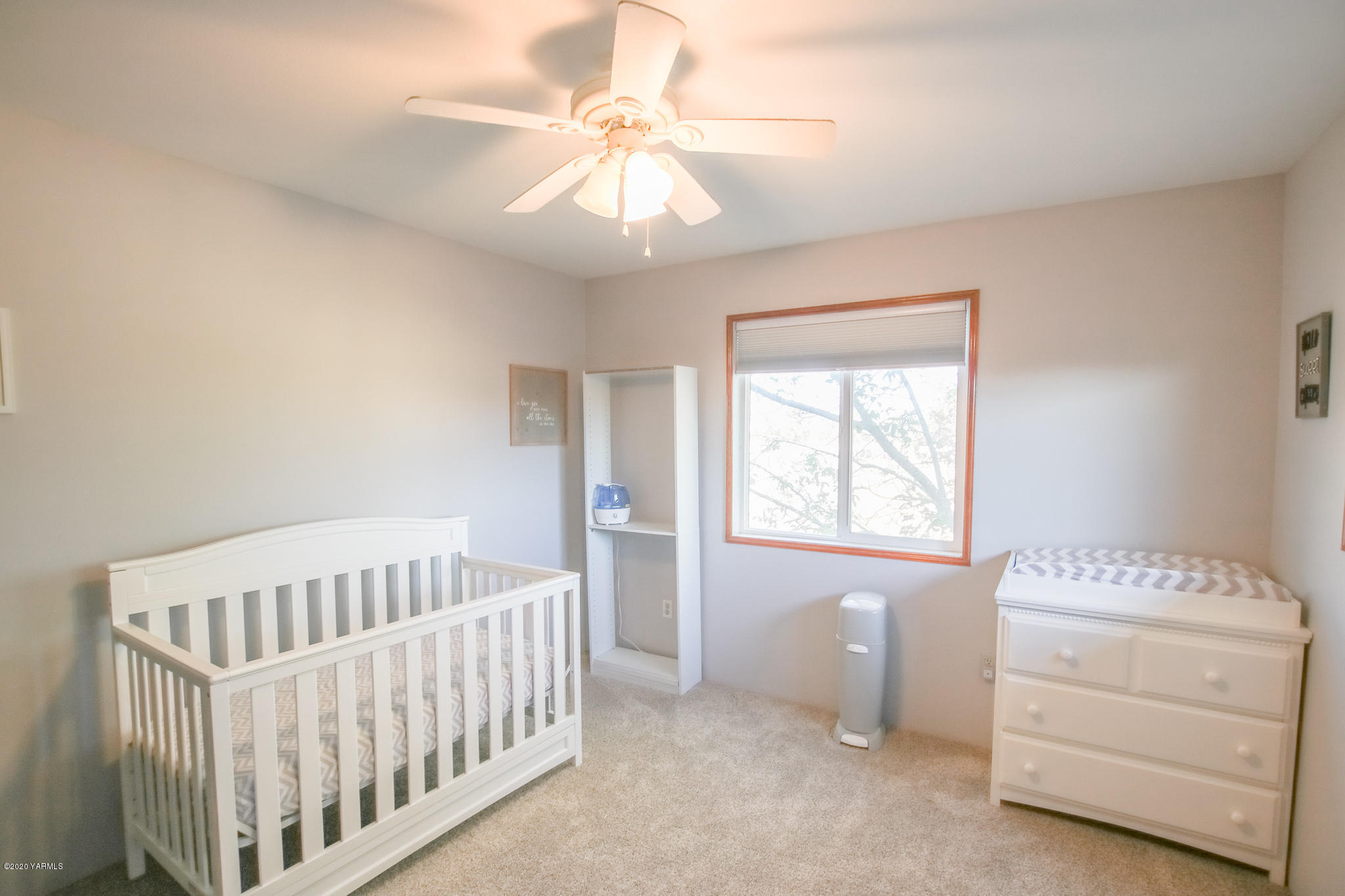 6608 Postma Road Yakima, WA 98901 - Photo 26 of 34 a bedroom with a bed and a baby crib