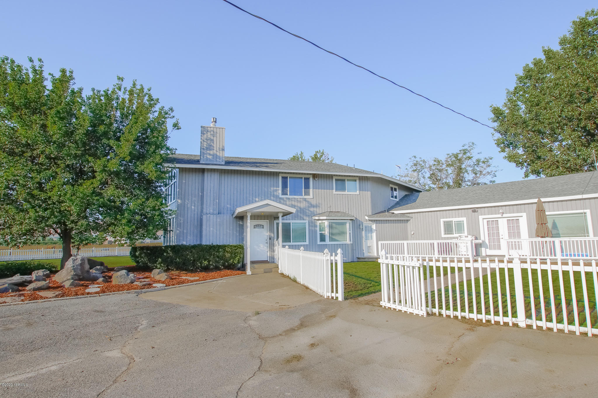 6608 Postma Road Yakima, WA 98901 - Photo 33 of 34 a view of a house with a small yard and plants