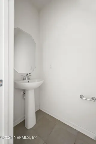 a bathroom with a sink and mirror