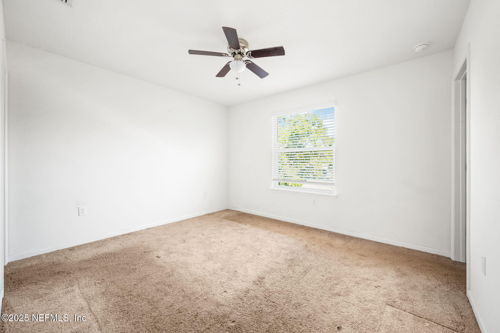 11799 Junegrass Road Jacksonville, FL 32258 - Photo 15 of 33 an empty room with ceiling fan and windows