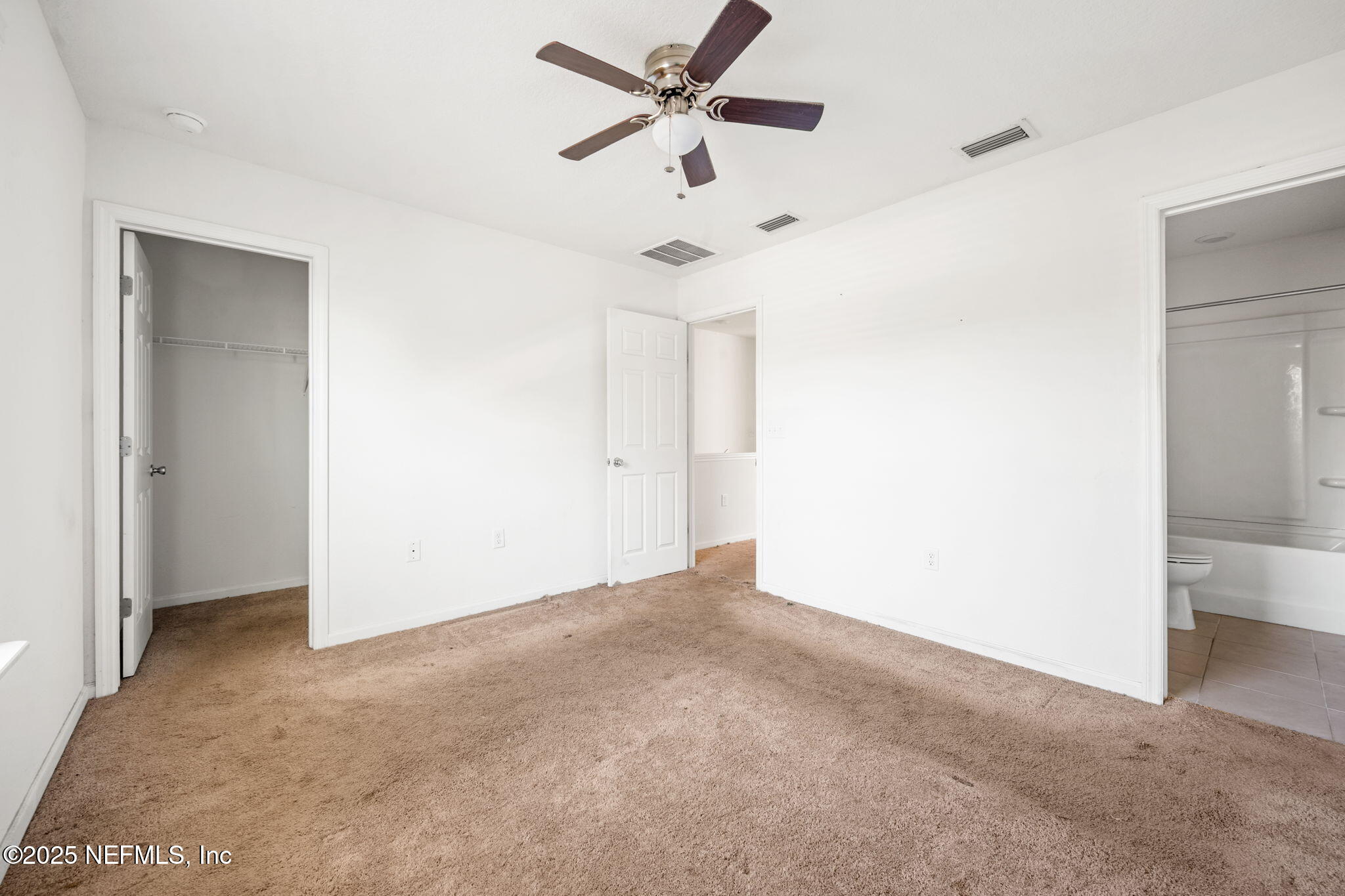 11799 Junegrass Road Jacksonville, FL 32258 - Photo 16 of 33 an empty room with a ceiling fan and a window