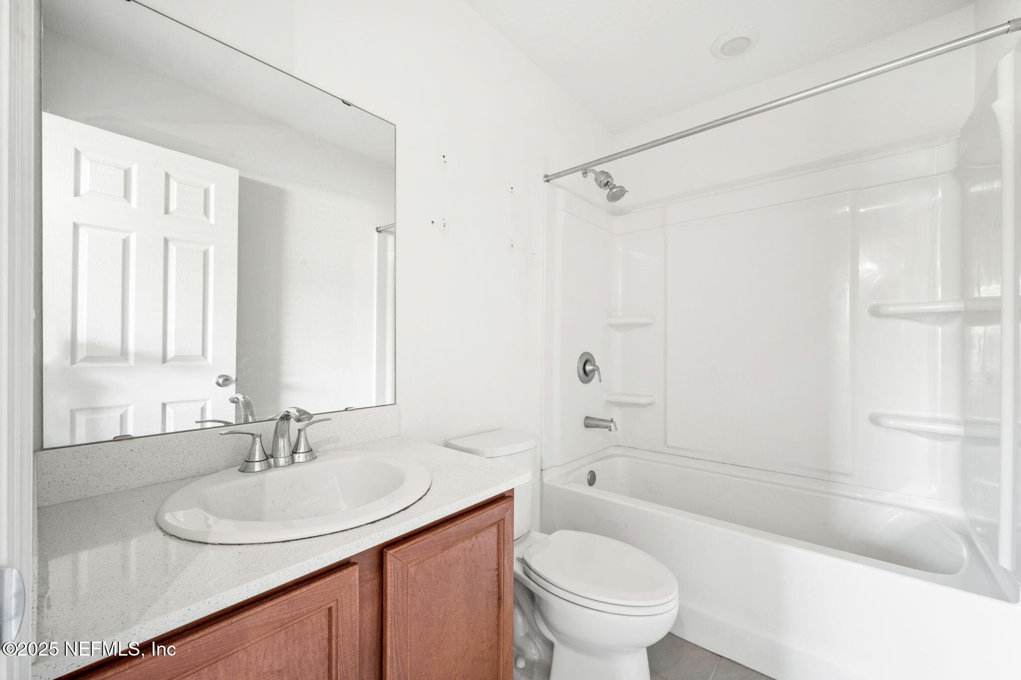 11799 Junegrass Road Jacksonville, FL 32258 - Photo 17 of 33 a bathroom with a sink toilet vanity and shower