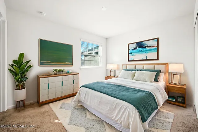 a bedroom with a bed and a potted plant