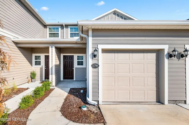 a front view of a house with a garden