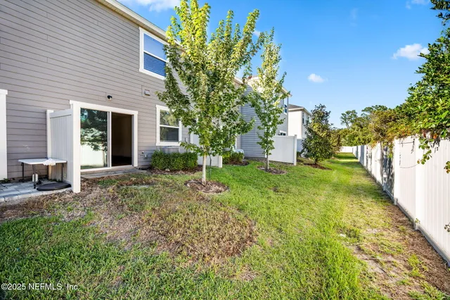 a view of a house with backyard and sitting area