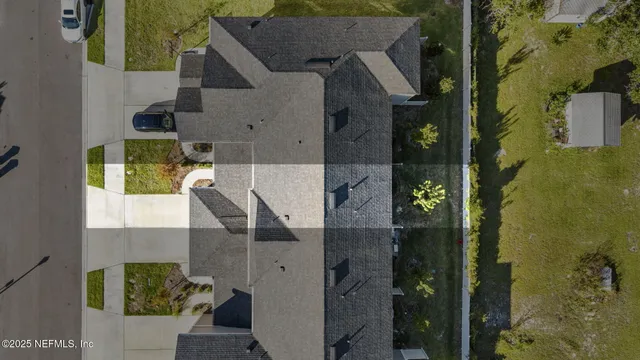aerial view of a house with a yard