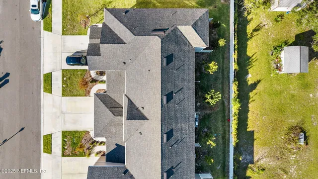 aerial view of a house with a yard
