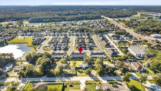 an aerial view of residential building and lake