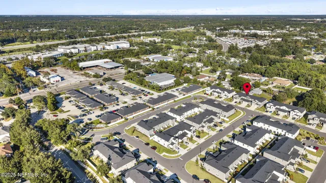 an aerial view of residential building with parking