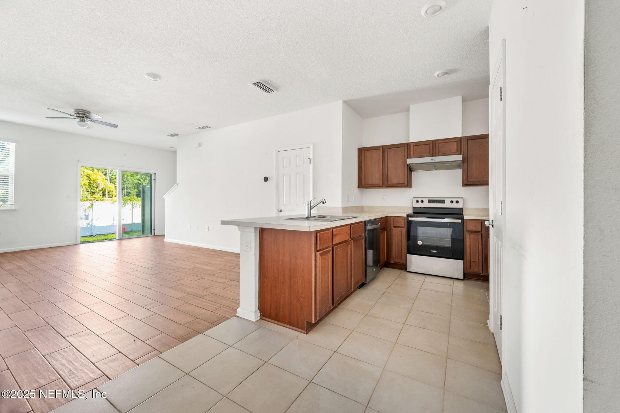 11799 Junegrass Road Jacksonville, FL 32258 - Photo 4 of 33 a kitchen with stainless steel appliances a sink a stove a microwave a sink a counter top space and cabinets
