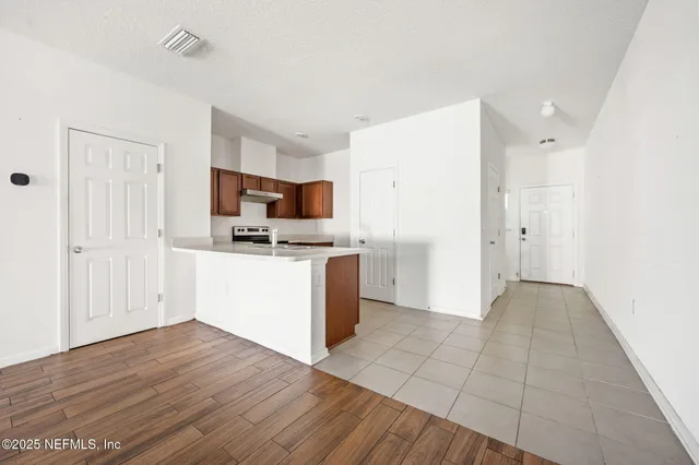 a view of kitchen with wooden floor and electronic appliances