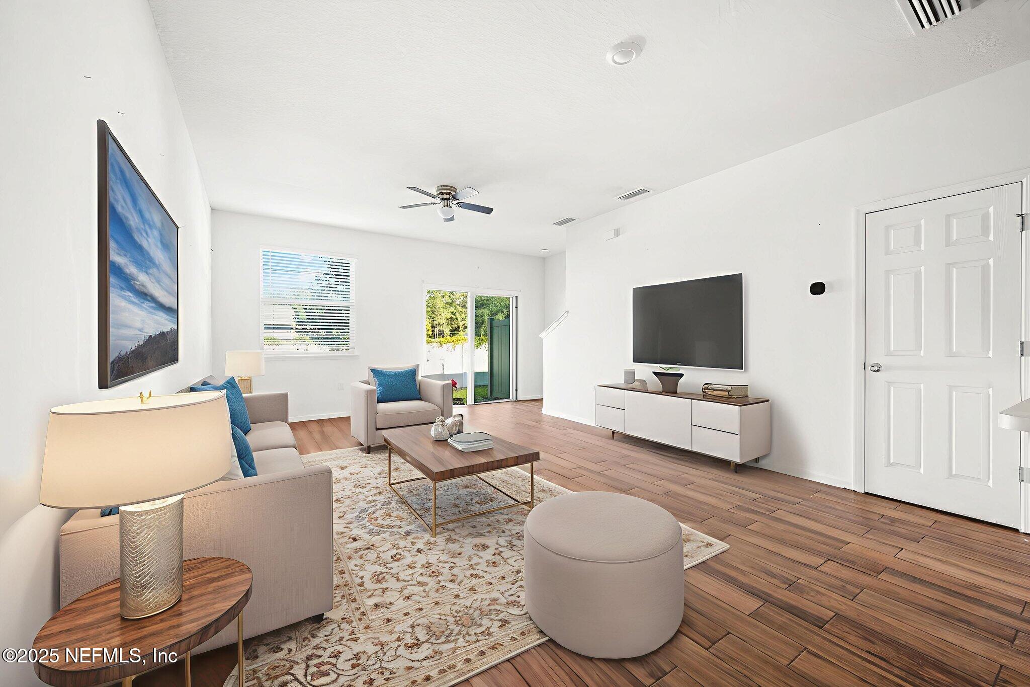 11799 Junegrass Road Jacksonville, FL 32258 - Photo 7 of 33 a living room with furniture and a flat screen tv