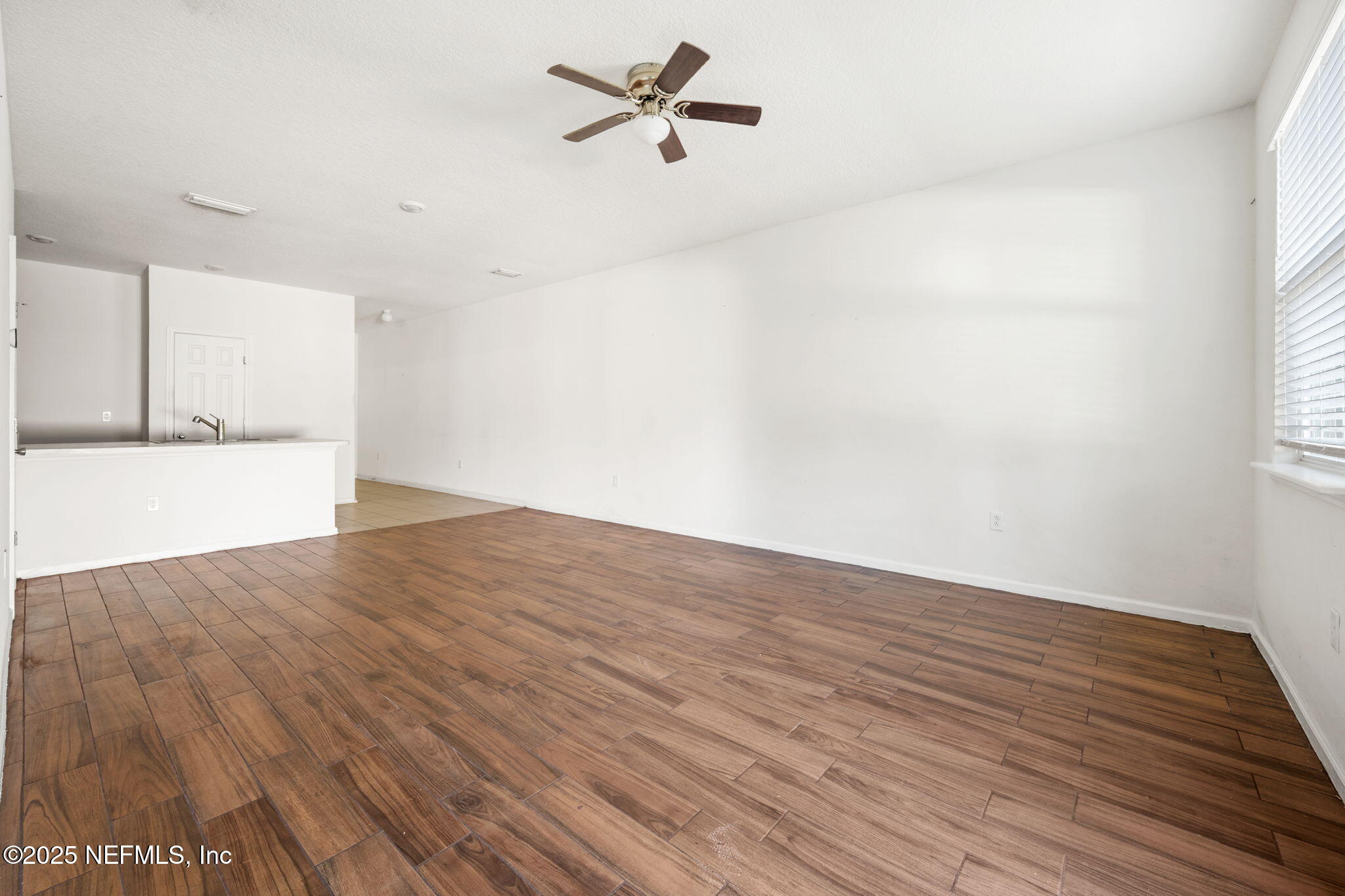 11799 Junegrass Road Jacksonville, FL 32258 - Photo 10 of 33 wooden floor in an empty room with a window