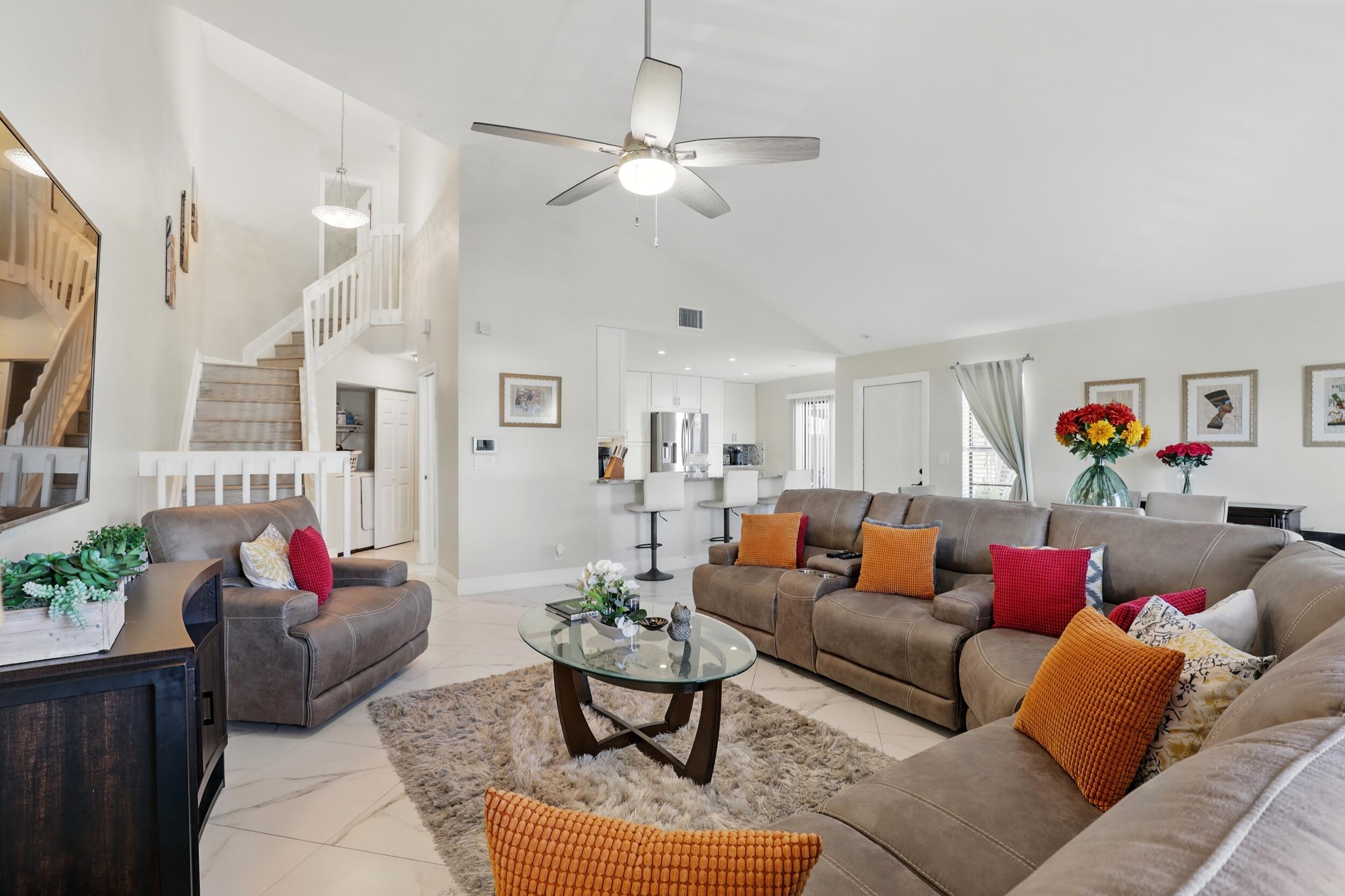 4491 Willow Pond Road, Unit B West Palm Beach, FL 33417 - Photo 14 of 29 a living room with furniture and a chandelier