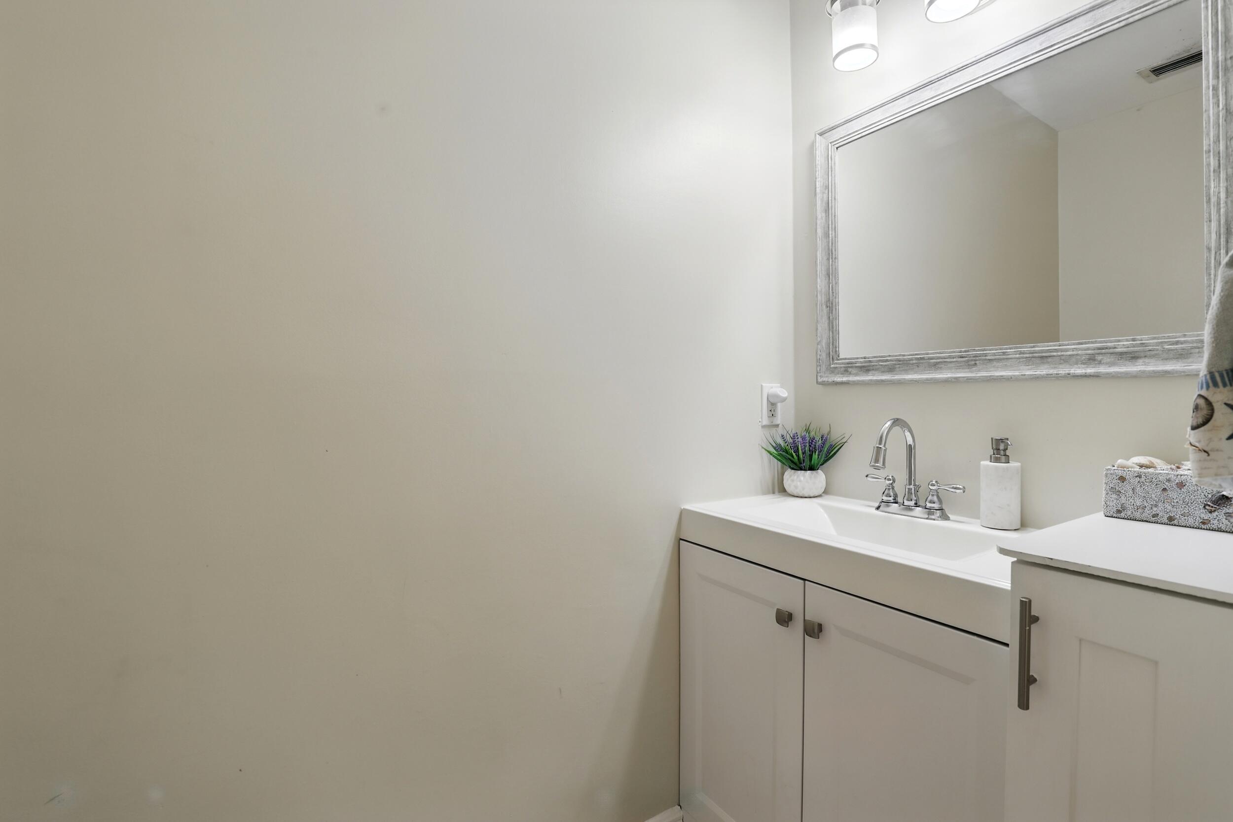 4491 Willow Pond Road, Unit B West Palm Beach, FL 33417 - Photo 16 of 29 a bathroom with a sink and a mirror