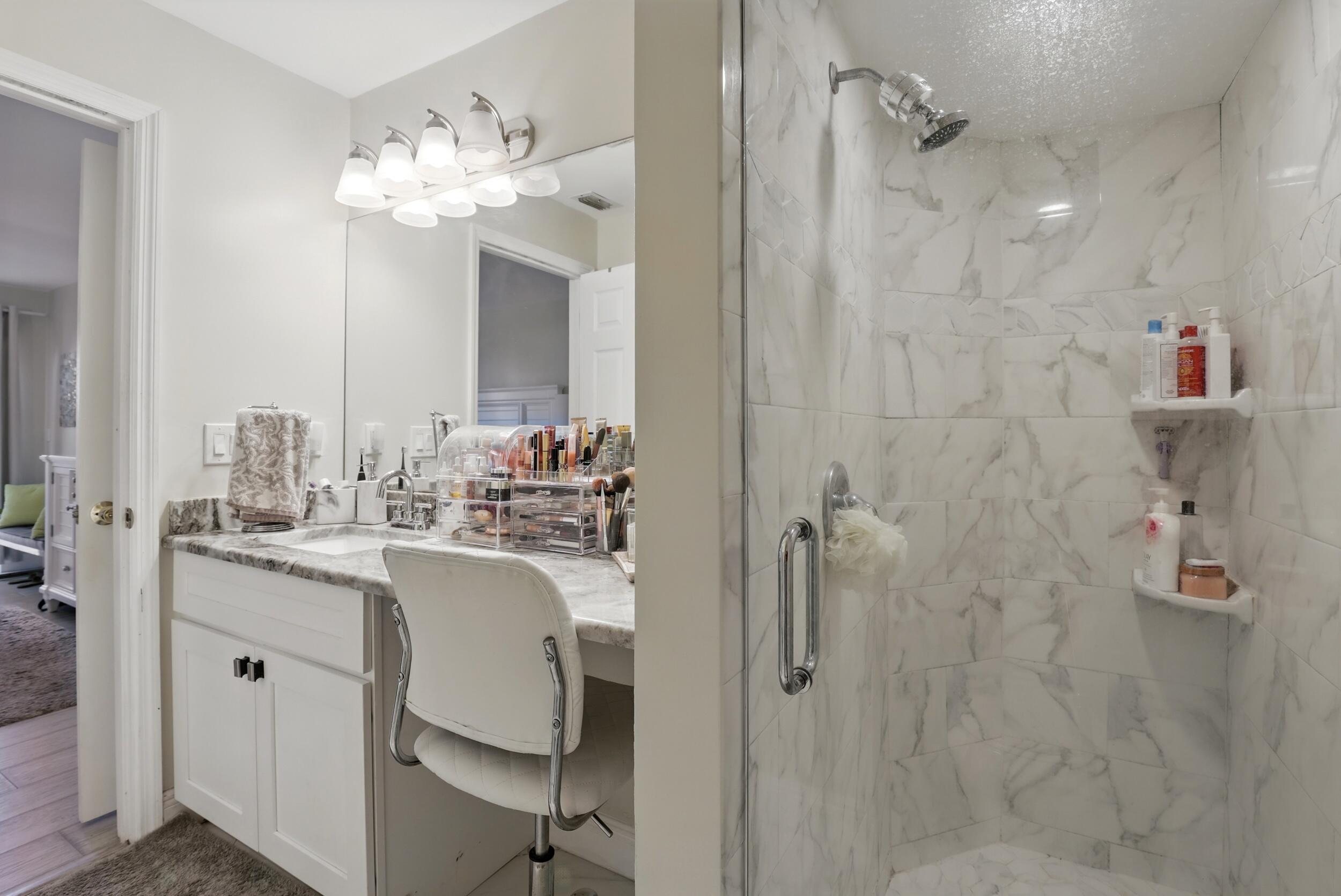 4491 Willow Pond Road, Unit B West Palm Beach, FL 33417 - Photo 22 of 29 a en suite bathroom with a double vanity sink mirror and shower