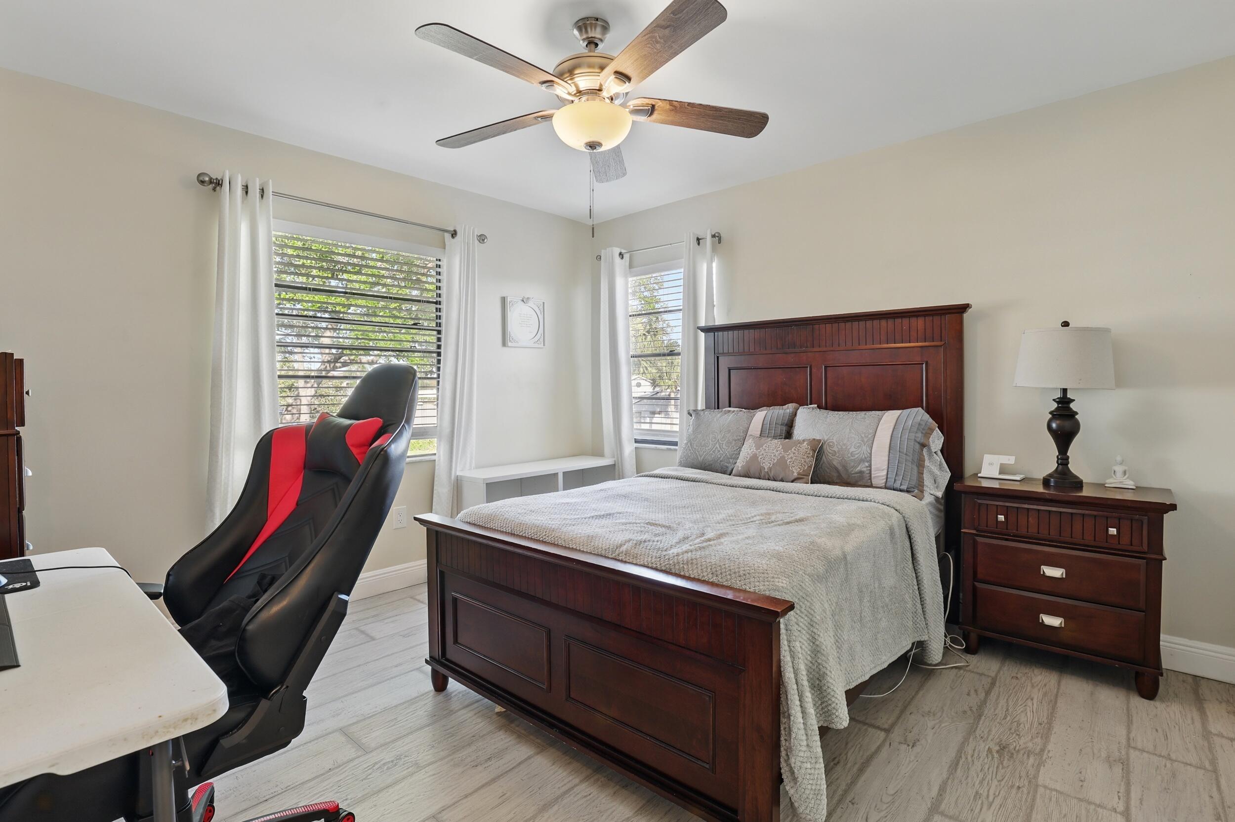 4491 Willow Pond Road, Unit B West Palm Beach, FL 33417 - Photo 23 of 29 a bed room with a bed and a chair