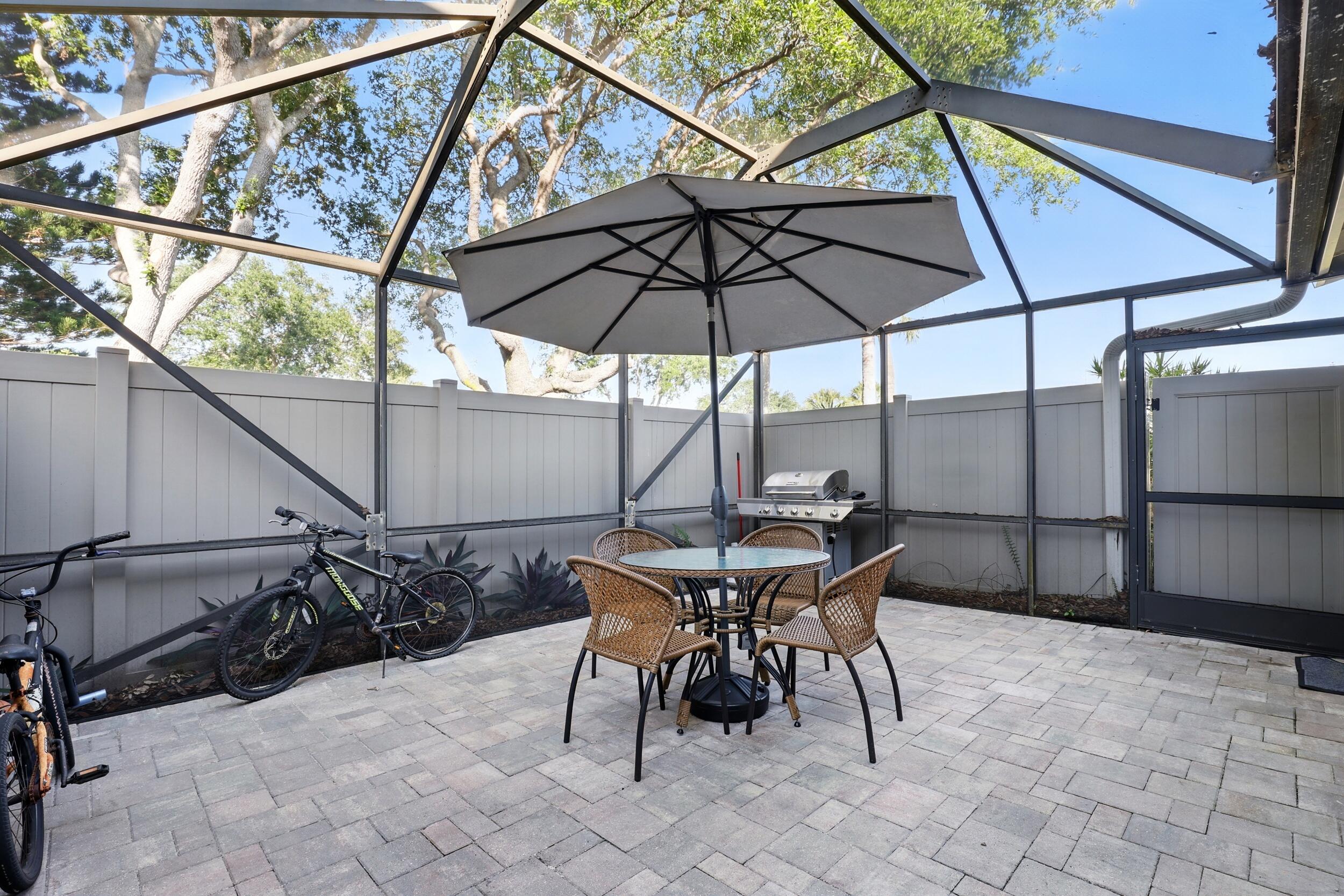 4491 Willow Pond Road, Unit B West Palm Beach, FL 33417 - Photo 29 of 29 a view of backyard with seating space and wooden under an umbrella