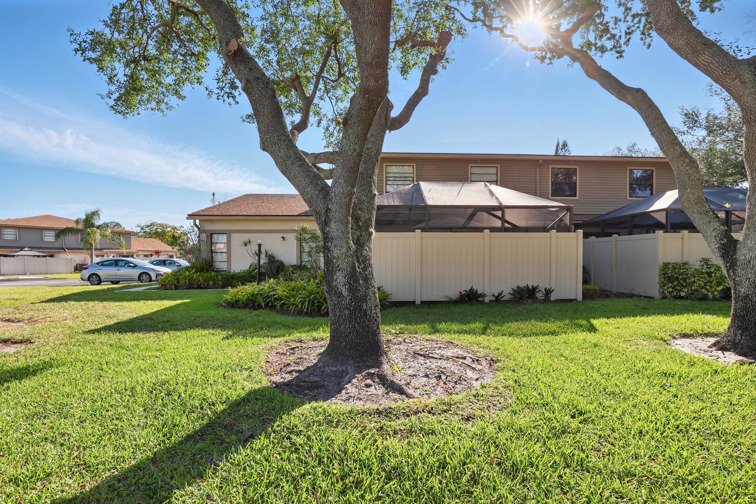 4491 Willow Pond Road, Unit B West Palm Beach, FL 33417 - Photo 3 of 29 a front view of a house with garden