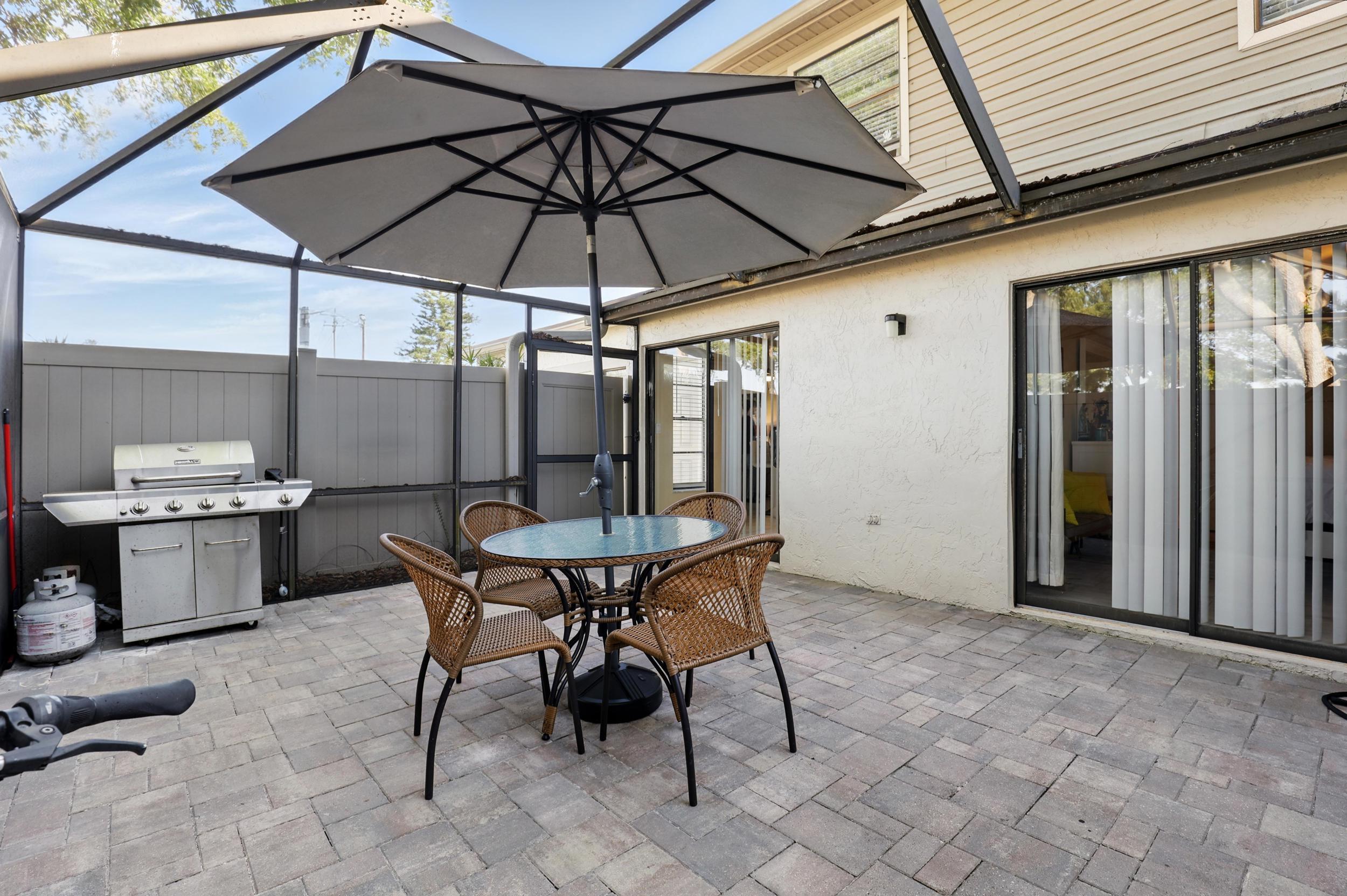 4491 Willow Pond Road, Unit B West Palm Beach, FL 33417 - Photo 4 of 29 a table and chairs in patio