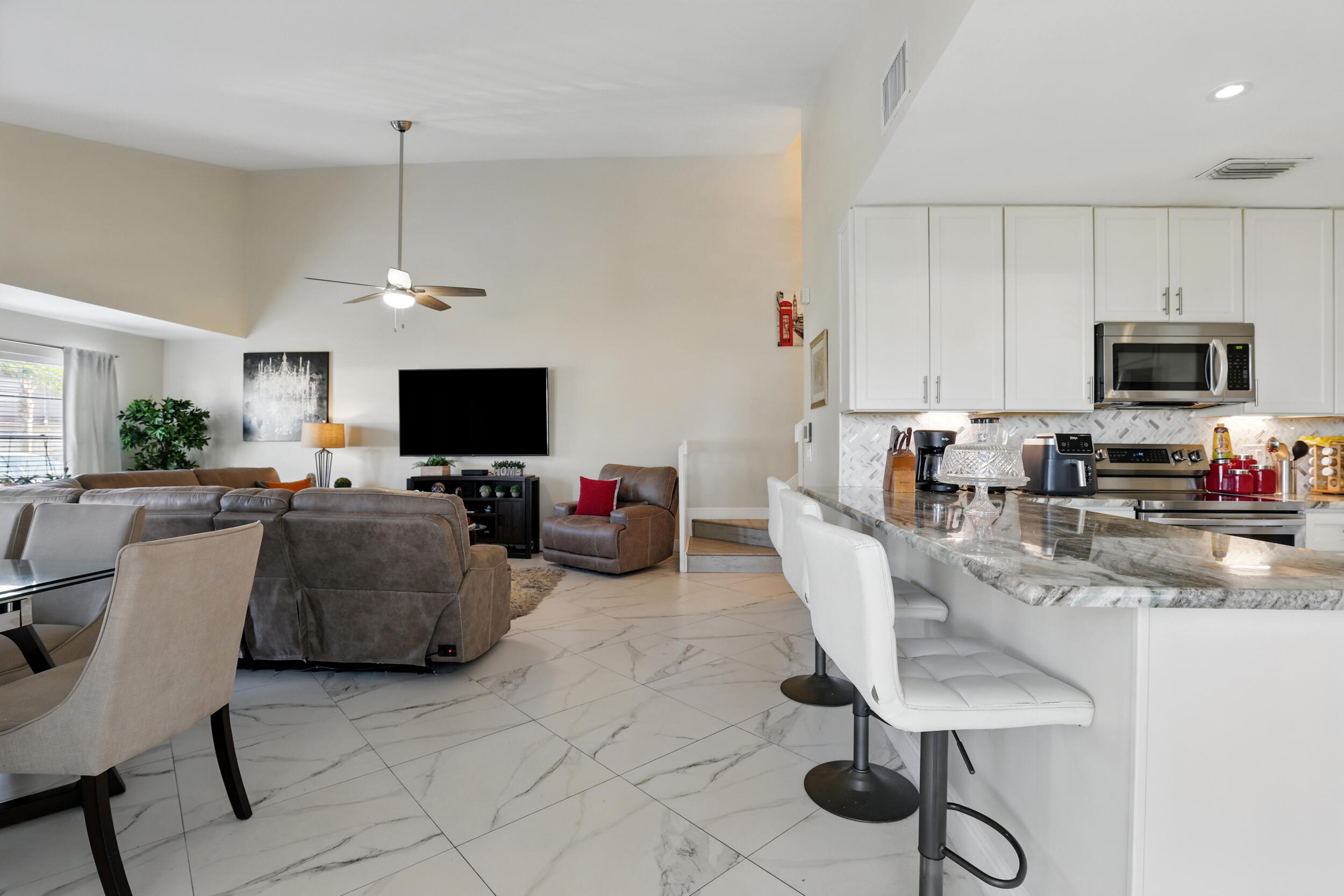 4491 Willow Pond Road, Unit B West Palm Beach, FL 33417 - Photo 7 of 29 a living room with furniture and a flat screen tv