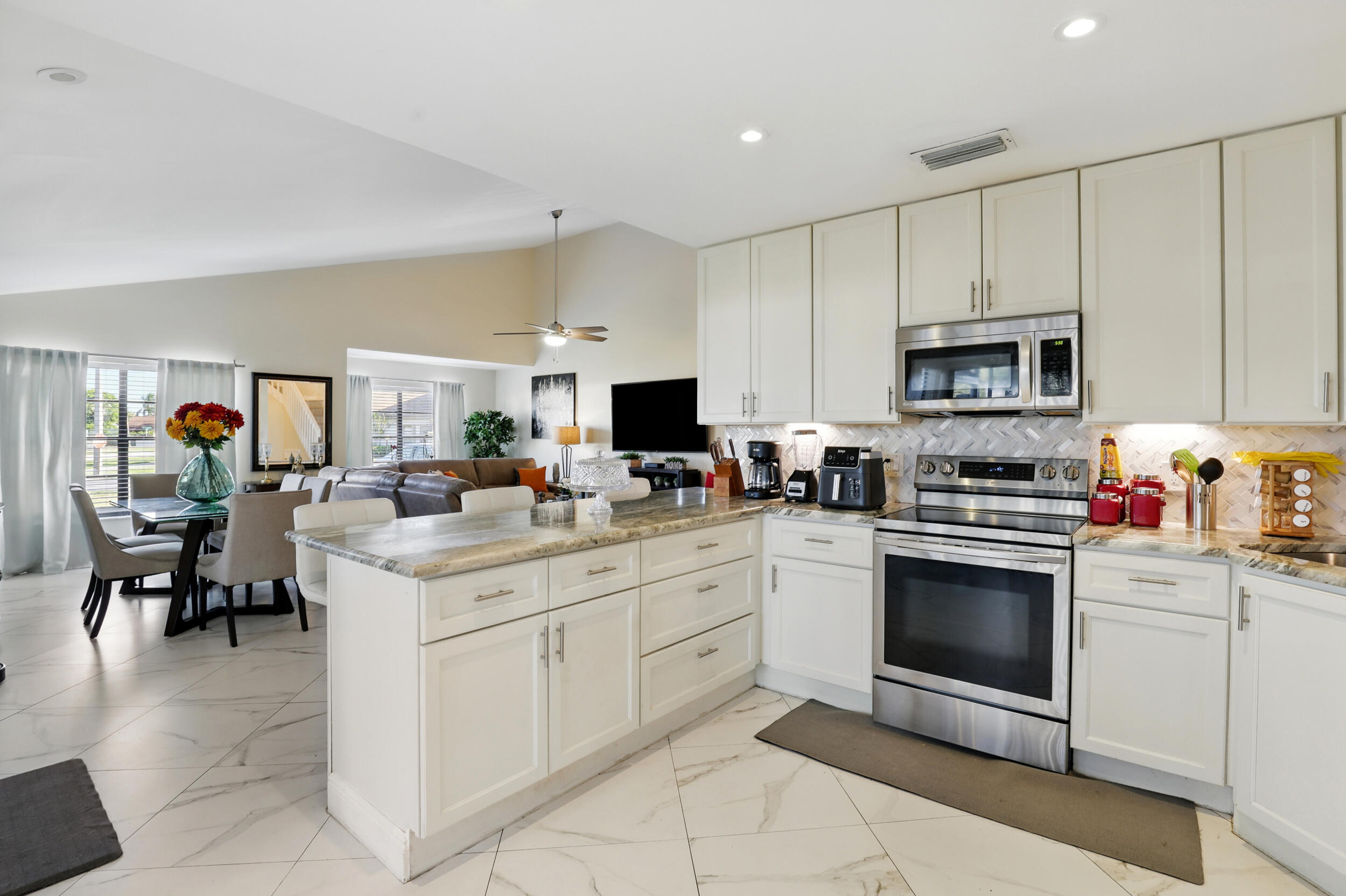 4491 Willow Pond Road, Unit B West Palm Beach, FL 33417 - Photo 8 of 29 a kitchen with cabinets stainless steel appliances and sink