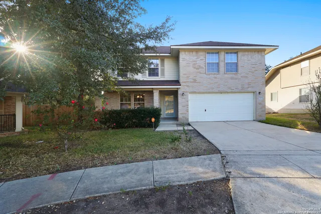 a front view of a house with a yard and a garage