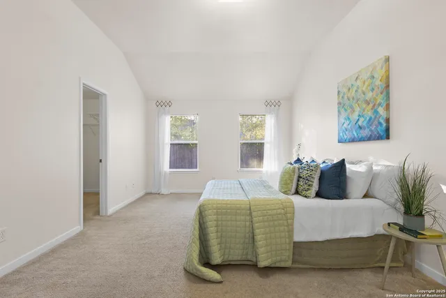 a living room with furniture and a painting on the wall