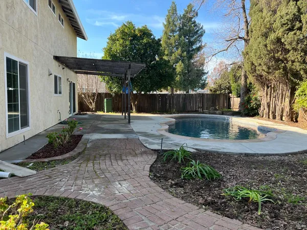 a view of a backyard with sitting area