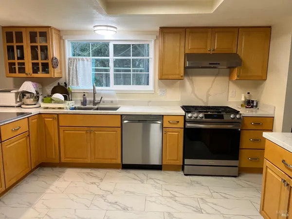 a kitchen with a sink stove and cabinets