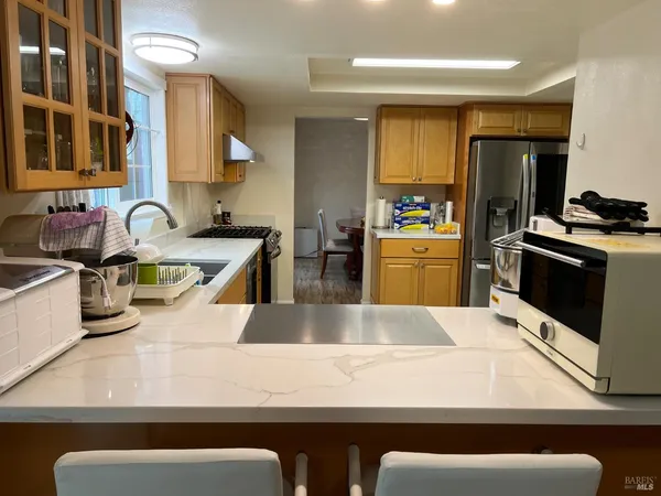a kitchen with stainless steel appliances granite countertop a sink and a stove