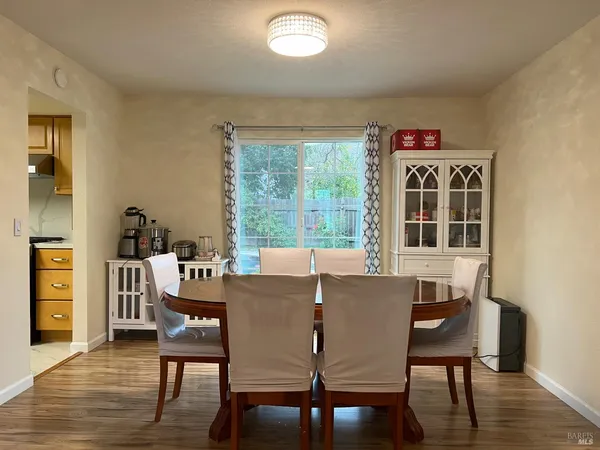 a view of a dining room with furniture window and wooden floor